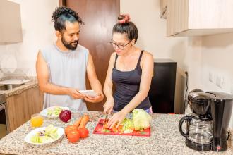 Man and woman cooking in the kitchen.