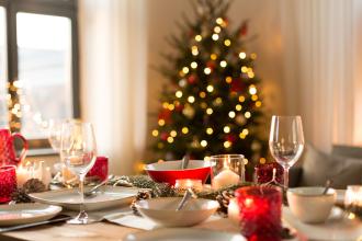 Table set for Christmas meal with Christmas tree in background