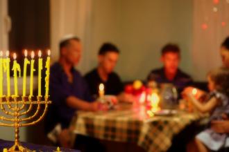 Manorah in the foreground, with family around table in background