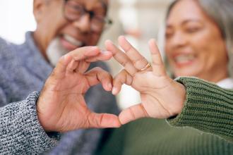 Couple making heart with hands