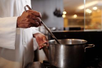 Stirring a pot of soup.