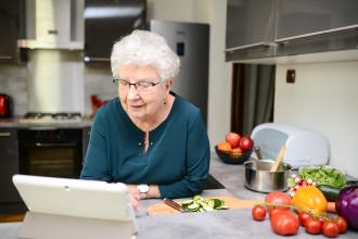 Woman reading digital cookbook.