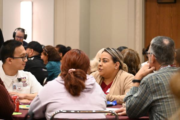 Participants discussing information on federal and local nutrition programs, healthy eating, and relevant community activities.