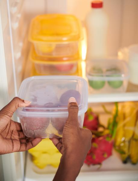 Storing food in containers in the refrigerator.